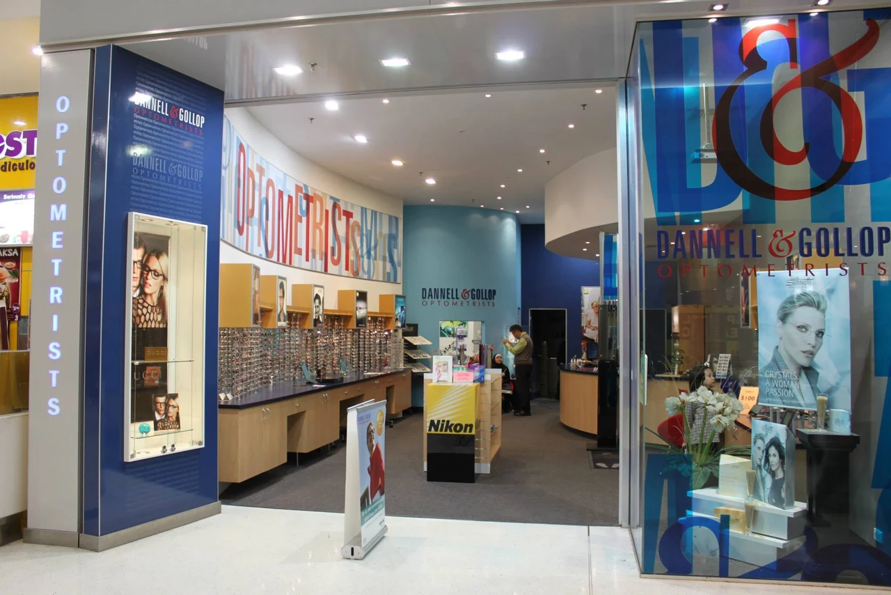 An earlier Dannell and Gollop storefront with blue signage and eyewear displays