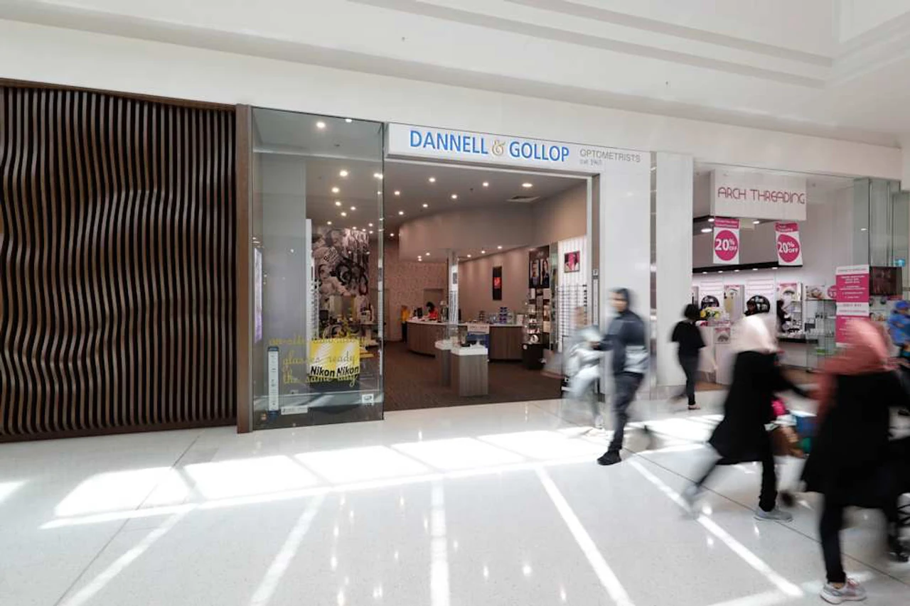 Our current Westfield Carousel storefront, with timber detailing and shoppers passing outside